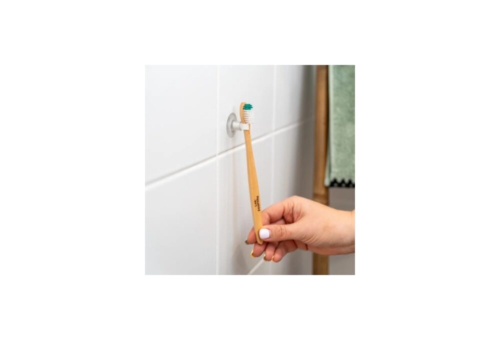 Ventosa amb suport per a capçals o raspalls de dents